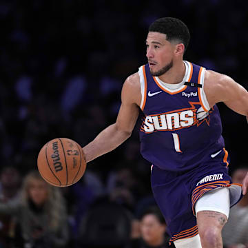 Mar 16, 2025; Los Angeles, California, USA; Phoenix Suns guard Devin Booker (1) dribbles the ball against the Los Angeles Lakers in the second half at Crypto.com Arena. Mandatory Credit: Kirby Lee-Imagn Images