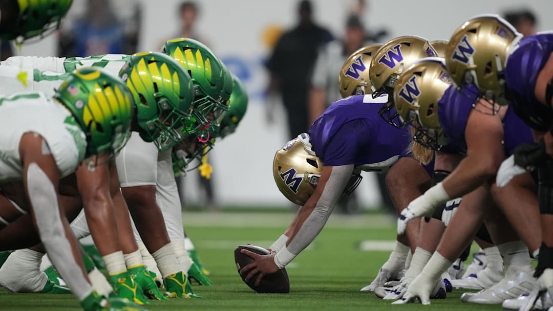 Dec 1, 2023; Las Vegas, NV, USA; Helmets of the Oregon Ducks and Washington Huskies at the line of scrimmage during the Pac-12 Championship game in the first half at Allegiant Stadium. Mandatory Credit: Kirby Lee-Imagn Images