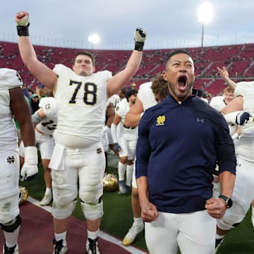 Nov 30, 2024; Los Angeles, California, USA; Notre Dame Fighting Irish head coach Marcus Freeman celebrates with players at the end of the game against the Southern California Trojans at United Airlines Field at Los Angeles Memorial Coliseum.