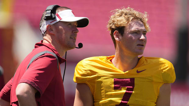 Southern California Trojans coach Lincoln Riley (left) talks with quarterback Miller Moss 