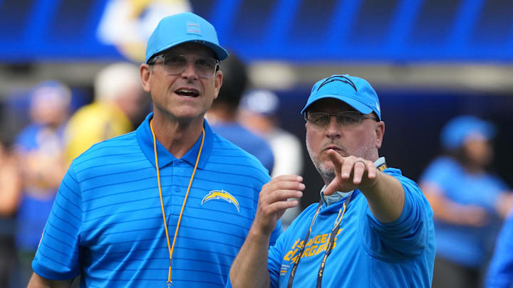 Aug 16, 2025; Inglewood, California, USA; Los Angeles Chargers coach Jim Harbaugh (left) and general manager Joe Hortiz react during the game against the Los Angeles Rams at SoFi Stadium. Mandatory Credit: Kirby Lee-Imagn Images