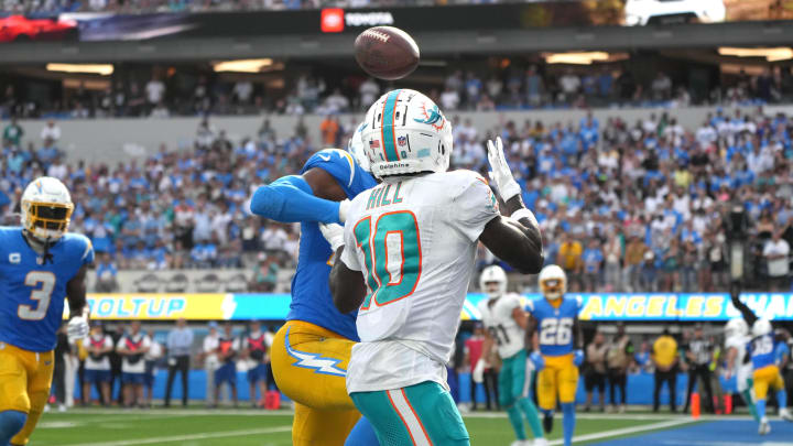 Miami Dolphins wide receiver Tyreek Hill (10) catches a 4-yard touchdown pass against Los Angeles Chargers cornerback Michael Davis (43) in the fourth quarter at SoFi Stadium.