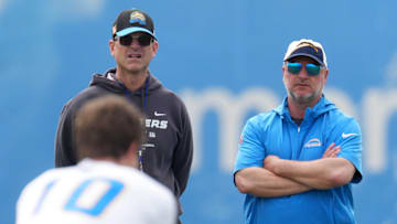 May 12, 2025; El Segundo, CA, USA; Los Angeles Chargers coach Jim Harbaugh (left) and general manager Joe Hortiz watch as quarterback Justin Herbert takes the snap during offseason workouts at The Bolt. Mandatory Credit: Kirby Lee-Imagn Images
