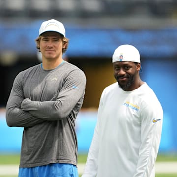 Aug 17, 2024; Inglewood, California, USA; Los Angeles Rams quarterbacks coach Shane Day (left), quarterback Justin Herbert (center) and linebackers coach Navorro Bowman during the game against the Los Angeles Rams at SoFi Stadium. Mandatory Credit: Kirby Lee-Imagn Images