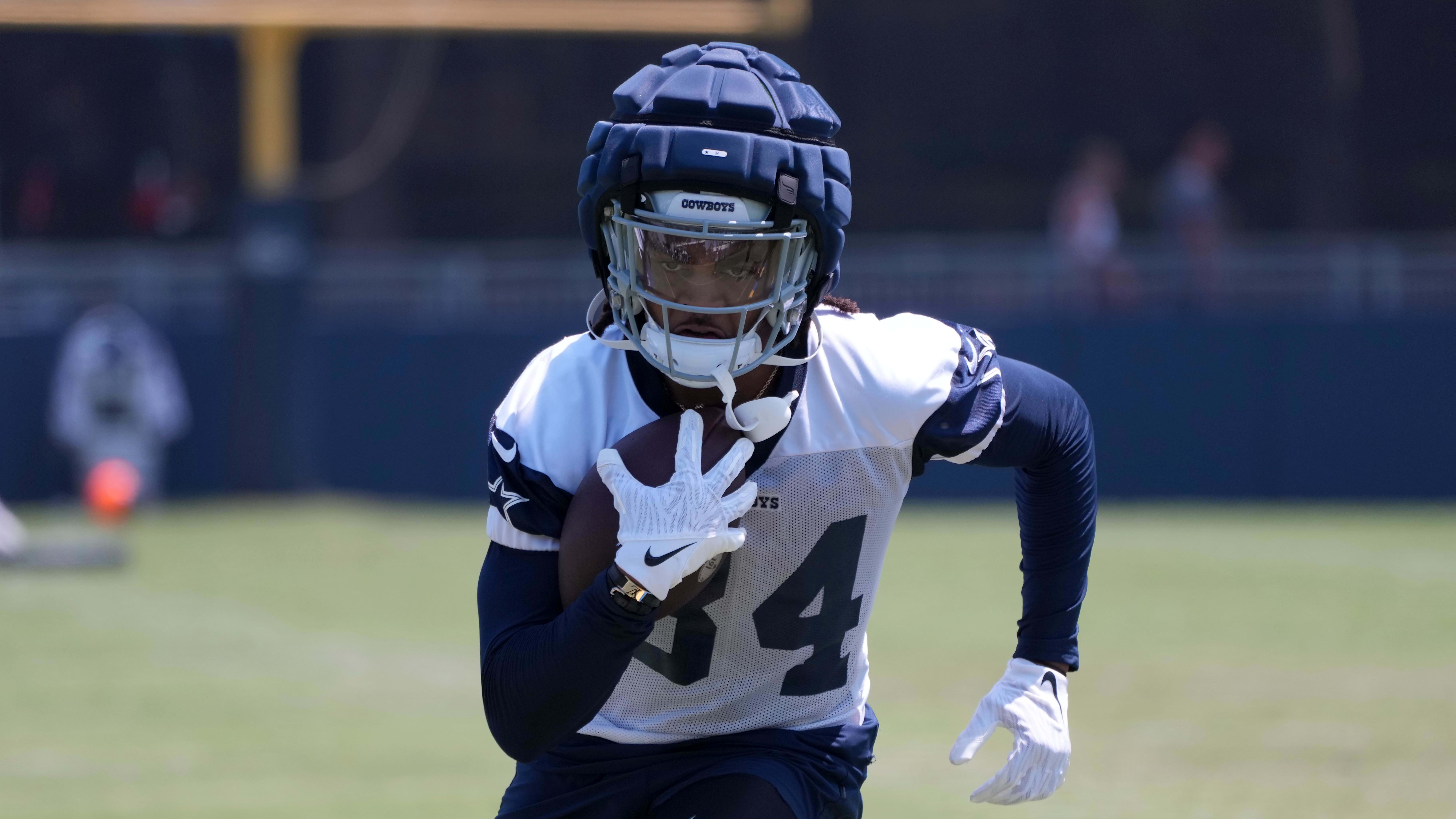 A Dallas Cowboys player wearing a guardian cap in practice