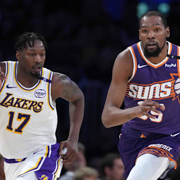 Mar 16, 2025; Los Angeles, California, USA; Phoenix Suns forward Kevin Durant (35) dribbles the ball against Los Angeles Lakers forward Dorian Finney-Smith (17) in the second half at Crypto.com Arena. Mandatory Credit: Kirby Lee-Imagn Images