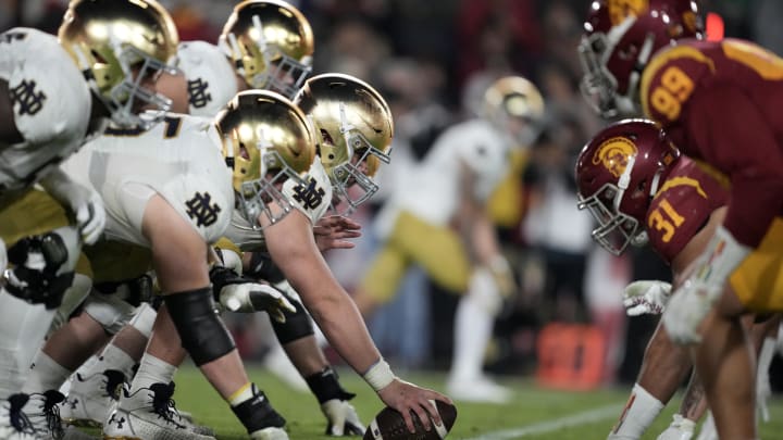 Nov 26, 2022; Los Angeles, California, USA; A general overall view of helmets at the line of scrimmage as Notre Dame Fighting Irish offensive lineman Zeke Correll (52) snaps the ball against the Southern California Trojans in the second half at United Airlines Field at Los Angeles Memorial Coliseum. Mandatory Credit: Kirby Lee-USA TODAY Sports