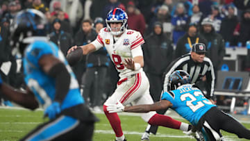 Nov 10, 2024; Munich, Germany; New York Giants quarterback Daniel Jones (8) is pressured by Carolina Panthers cornerback Dane Jackson (23) in the second half during the 2024 NFL Munich Game at Allianz Arena.  