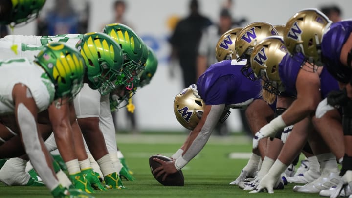 Dec 1, 2023; Las Vegas, NV, USA; Helmets of the Oregon Ducks and Washington Huskies at the line of scrimmage during the Pac-12 Championship game in the first half at Allegiant Stadium. Mandatory Credit: Kirby Lee-USA TODAY Sports