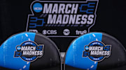 Team bench chairs with the March Madness Elite 8 and Sweet 16 logos