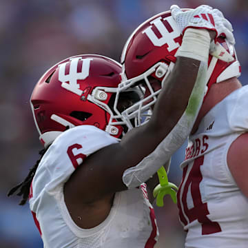 Indiana Hoosiers running back Justice Ellison (6) celebrates with offensive lineman Bray Lynch (74) after scoring on a 1-yard touchdown run in the first half against the UCLA Bruins at Rose Bowl.