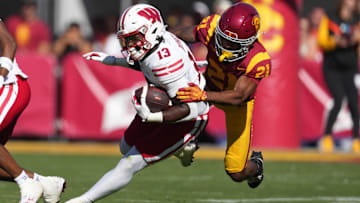 Sep 28, 2024; Los Angeles, California, USA; Wisconsin Badgers running back Darrion Dupree (13) carries the ball against Southern California Trojans cornerback Greedy Vance Jr. (21) in the second half at United Airlines Field at Los Angeles Memorial Coliseum. Mandatory Credit: Kirby Lee-Imagn Images