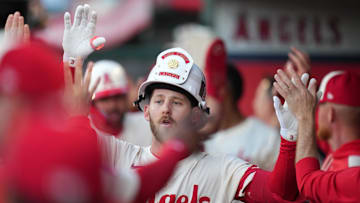 May 8, 2025; Anaheim, California, USA; Los Angeles Angels left fielder Taylor Ward (3) wears a fireman helmet after hitting a two-run home run in the first inning against the Toronto Blue Jays at Angel Stadium. Mandatory Credit: Kirby Lee-Imagn Images