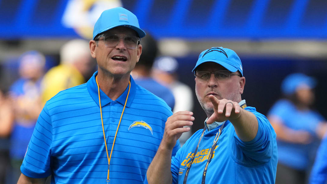 Aug 16, 2025; Inglewood, California, USA; Los Angeles Chargers coach Jim Harbaugh (left) and general manager Joe Hortiz react during the game against the Los Angeles Rams at SoFi Stadium. Mandatory Credit: Kirby Lee-Imagn Images
