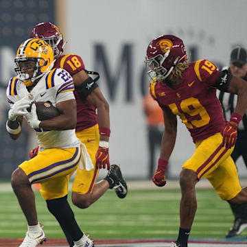 Sep 1, 2024; Paradise, Nevada, USA;  LSU Tigers running back John Emery Jr. (22) carries the ball against  Southern California Trojans cornerback John Humphrey (19) in the second half at Allegiant Stadium. Mandatory Credit: Kirby Lee-Imagn Images