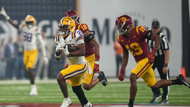 Sep 1, 2024; Paradise, Nevada, USA;  LSU Tigers running back John Emery Jr. (22) carries the ball against  Southern California Trojans cornerback John Humphrey (19) in the second half at Allegiant Stadium. Mandatory Credit: Kirby Lee-Imagn Images