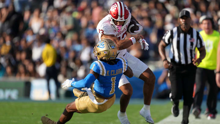 Indiana Hoosiers wide receiver Elijah Sarratt (13) carries the ball against UCLA Bruins defensive back Kanye Clark (1) in the first half at Rose Bowl.