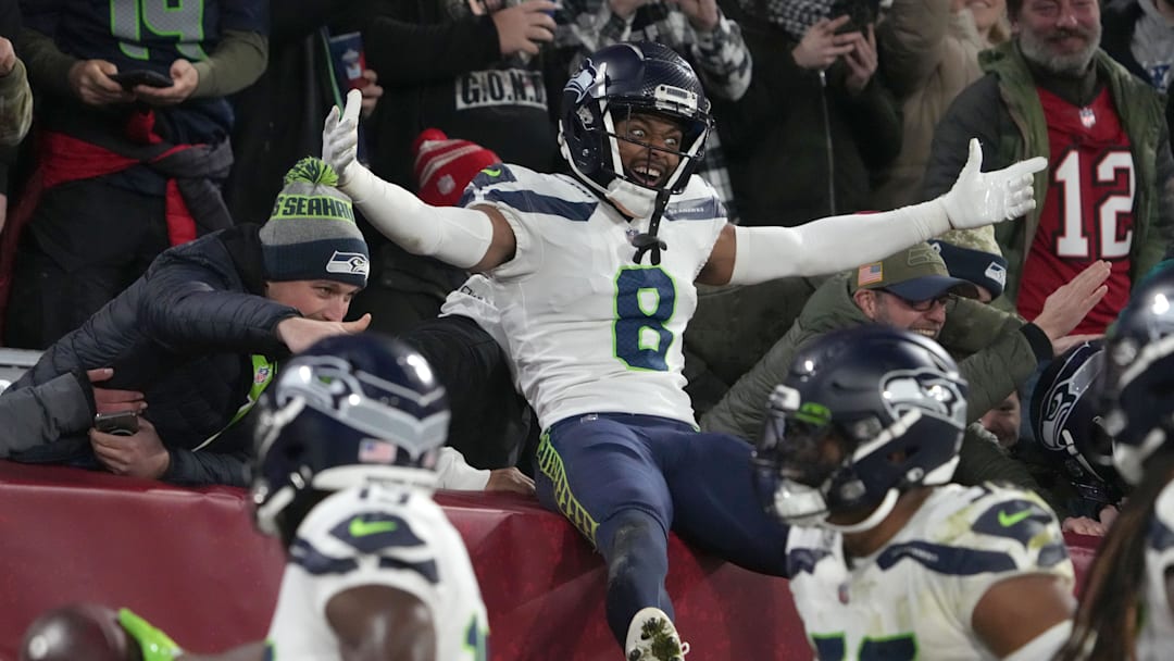 Nov 13, 2022; Munich, Germany; Seattle Seahawks cornerback Coby Bryant (8) celebrates with fans in the second half against the Tampa Bay Buccaneers during an NFL International Series game at Allianz Arena. Mandatory Credit: Kirby Lee-Imagn Images