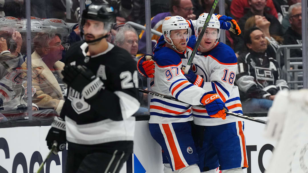 Apr 21, 2025; Los Angeles, California, USA; Edmonton Oilers center Connor McDavid (97) and left wing Zach Hyman (18) celebrate after a goal in the third period of game one of the first round of the 2025 Stanley Cup Playoffs against the LA Kings at Crypto.com Arena. Mandatory Credit: Kirby Lee-Imagn Images