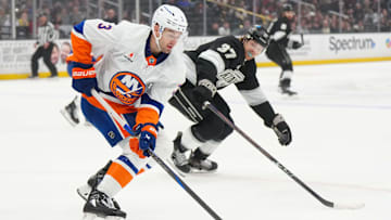 Mar 11, 2025; Los Angeles, California, USA; New York Islanders defenseman Adam Pelech (3) and LA Kings left wing Warren Foegele (37)  reach for the puck in the first period at the Crypto.com Arena. Mandatory Credit: Kirby Lee-Imagn Images