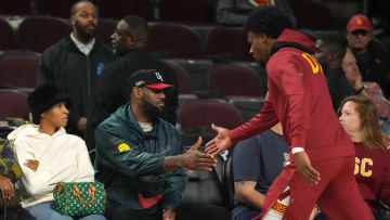 Jan 10, 2024; Los Angeles, California, USA; Southern California Trojans guard Bronny James (6) is greeted by father LeBron James during the game against the Washington State Cougars at Galen Center. Mandatory Credit: Kirby Lee-USA TODAY Sports