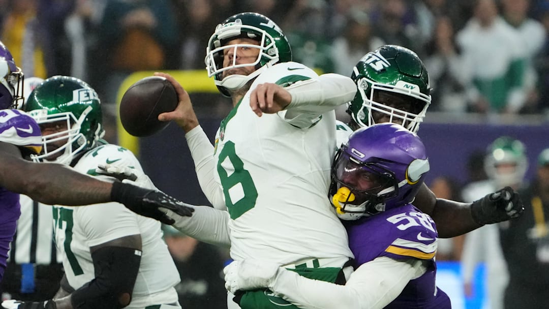 Oct 6, 2024; London, United Kingdom; New York Jets quarterback Aaron Rodgers throws the ball under pressure from Minnesota Vikings linebacker Jonathan Greenard.