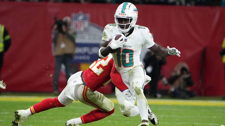 Nov 5, 2023; Frankfurt, Germany; Miami Dolphins wide receiver Tyreek Hill (10) carries the ball against Kansas City Chiefs linebacker Nick Bolton (32) in the second half during an NFL International Series game at Deutsche Bank Park. Mandatory Credit: Kirby Lee-Imagn Images