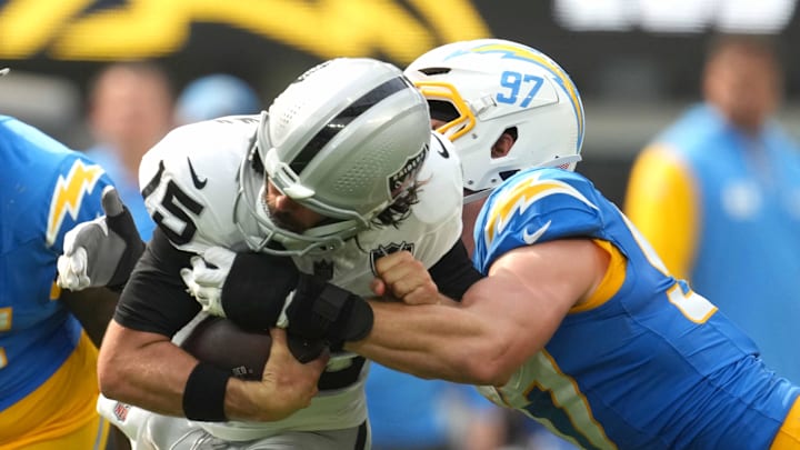 Sep 8, 2024; Inglewood, California, USA; Los Angeles Chargers linebacker Joey Bosa (97) tackles Las Vegas Raiders quarterback Gardner Minshew (15) in the second half at SoFi Stadium. Mandatory Credit: Kirby Lee-Imagn Images