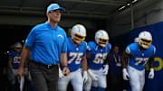 Aug 16, 2025; Inglewood, California, USA; Los Angeles Chargers coach Jim Harbaugh, center Bradley Bozeman (75), guard Jamaree Salyer (68) and guard Zion Johnson (77) enter the field before the game against the Los Angeles Rams at SoFi Stadium. Mandatory Credit: Kirby Lee-Imagn Images