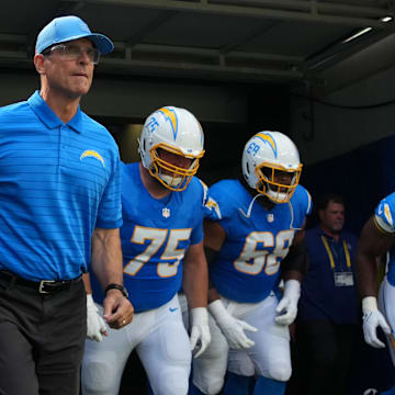 Aug 16, 2025; Inglewood, California, USA; Los Angeles Chargers coach Jim Harbaugh, center Bradley Bozeman (75), guard Jamaree Salyer (68) and guard Zion Johnson (77) enter the field before the game against the Los Angeles Rams at SoFi Stadium. Mandatory Credit: Kirby Lee-Imagn Images
