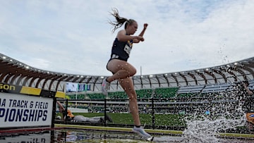 Jun 9, 2022; Eugene, OR, USA; Ceili McCabe of West Virginia races over the water jump in the women's steeplechase during the NCAA Track and Field Championships at Hayward Field. Mandatory Credit: Kirby Lee-Imagn Images