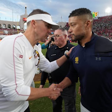 Nov 30, 2024; Los Angeles, California, USA; Southern California Trojans head coach Lincoln Riley and Notre Dame Fighting Irish head coach Marcus Freeman shake hands after the game at United Airlines Field at Los Angeles Memorial Coliseum. Mandatory Credit: Kirby Lee-Imagn Images