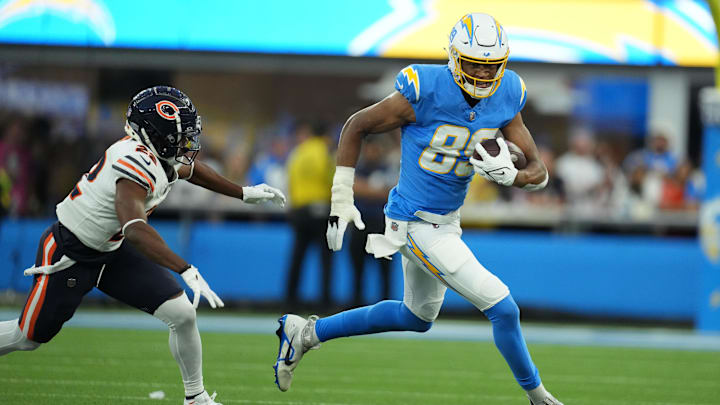 Oct 29, 2023; Inglewood, California, USA; Los Angeles Chargers tight end Donald Parham Jr. (89) carries the ball against Chicago Bears defensive back Elijah Hicks (22) in the first half at SoFi Stadium. Mandatory Credit: Kirby Lee-Imagn Images
