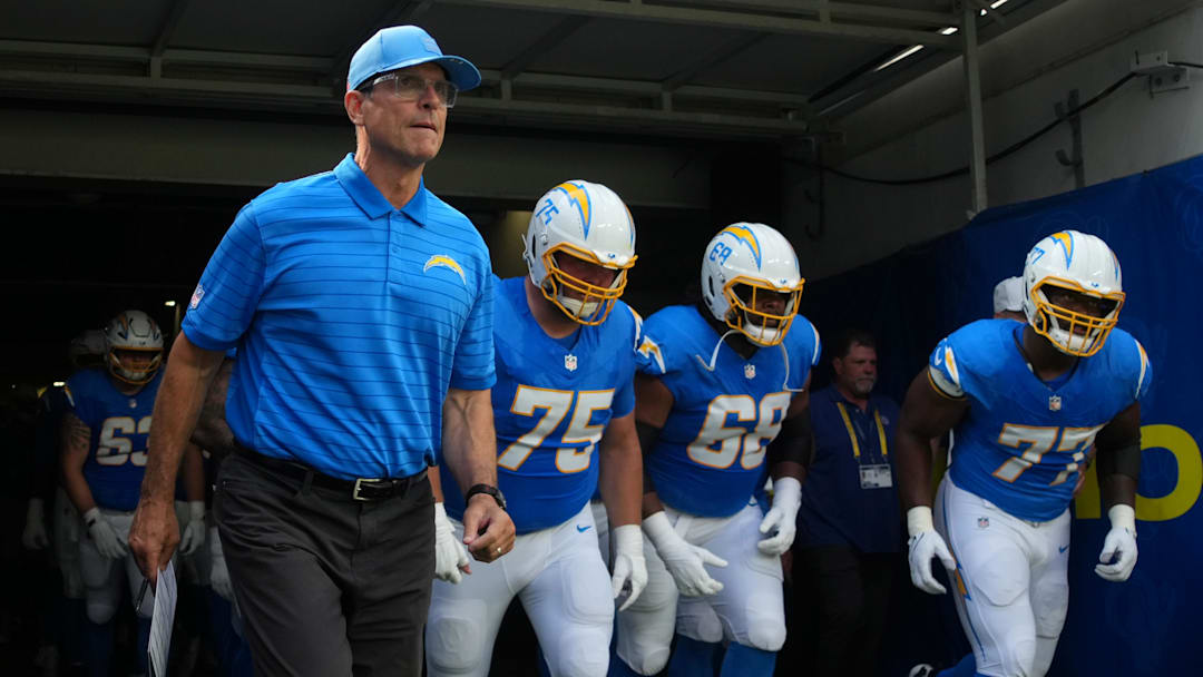 Aug 16, 2025; Inglewood, California, USA; Los Angeles Chargers coach Jim Harbaugh, center Bradley Bozeman (75), guard Jamaree Salyer (68) and guard Zion Johnson (77) enter the field before the game against the Los Angeles Rams at SoFi Stadium. Mandatory Credit: Kirby Lee-Imagn Images