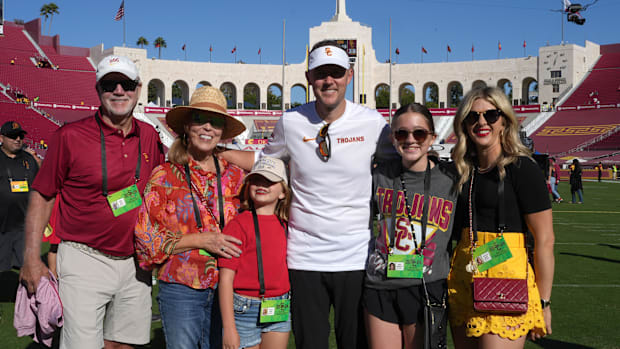 Los Angeles, California, USA; Southern California Trojans head coach Lincoln Riley (center) poses with father Mike Riley, mot