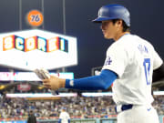 Dodgers designated hitter Shohei Ohtani returns to the dugout after scoring in the sixth inning against the Diamondbacks at Dodger Stadium.