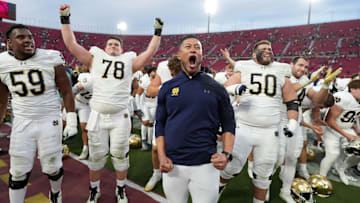 Notre Dame Fighting Irish head coach Marcus Freeman celebrates with players at the end of the game against the Southern California Trojans at United Airlines Field at Los Angeles Memorial Coliseum. 