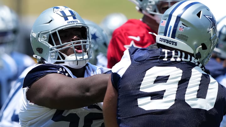 Dallas Cowboys guard Tyler Booker defends against defensive tackle Solomon Thomas during training camp in Oxnard. Dallas Cowboys guard Tyler Booker defends against defensive tackle Solomon Thomas during training camp in Oxnard.