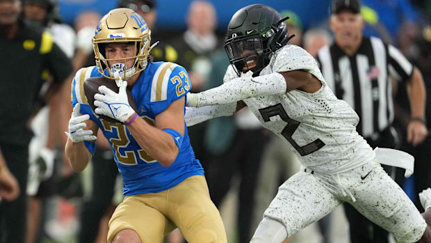 Oct 23, 2021; Pasadena, California, USA; UCLA Bruins wide receiver Chase Cota (23) is defended by Oregon Ducks cornerback Myk