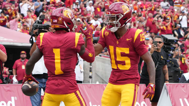 Sep 2, 2023; Los Angeles, California, USA; Southern California Trojans wide receiver Zachariah Branch (1) celebrates with wide receiver Dorian Singer (15) after scoring on a 22-yard touchdown pass against the Nevada Wolf Pack in the first half at United Airlines Field at Los Angeles Memorial Coliseum. Mandatory Credit: Kirby Lee-USA TODAY Sports