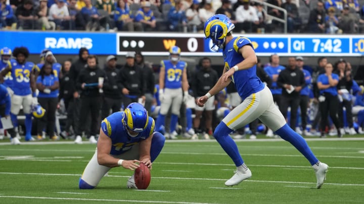 Dec 17, 2023; Inglewood, California, USA; Los Angeles Rams place kicker Lucas Havrisik (8) kicks a field goal out of the hoid of punter Ethan Evans (42) against the Washington Commanders in the first half at SoFi Stadium. Mandatory Credit: Kirby Lee-USA TODAY Sports