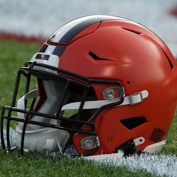 A Cleveland Browns helmet on the field at Tom Benson Hall of Fame Stadium.