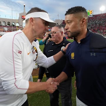 Nov 30, 2024; Los Angeles, California, USA; Southern California Trojans head coach Lincoln Riley and Notre Dame Fighting Irish head coach Marcus Freeman shake hands after the game at United Airlines Field at Los Angeles Memorial Coliseum. 