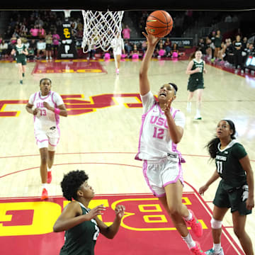 Feb 19, 2025; Los Angeles, California, USA; Southern California Trojans guard JuJu Watkins (12) shoots the ball against Michigan State Spartans guard Nyla Hampton (22) and guard Jocelyn Tate (11) in the second half at the Galen Center. Mandatory Credit: Kirby Lee-Imagn Images