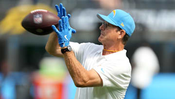 Aug 17, 2024; Inglewood, California, USA; Los Angeles Chargers coach Jim Harbaugh catches the ball during the game against th eLos Angeles Rams in the first half at SoFi Stadium. Mandatory Credit: Kirby Lee-Imagn Images