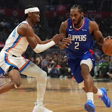 LA Clippers forward Kawhi Leonard (right) dribbles the ball against Oklahoma City Thunder guard Shai Gilgeous-Alexander in the first half at Crypto.com Arena. Mandatory Credit: Kirby Lee-Imagn Images