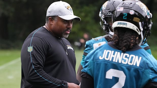 Jacksonville Jaguars running backs coach Jerry Mack talks with running back D'Ernest Johnson during practice at The Grove.