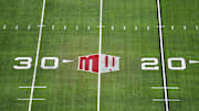 The Mountain West conference logo on the field at Allegiant Stadium. 