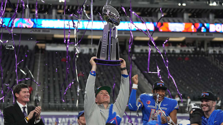 Dec 2, 2023; Las Vegas, NV, USA; Boise State Broncos head coach Spencer Danielson holds the Craig Thompson tropny after 44-20 victory over the UNLV Rebels in the Mountain West Championship at Allegiant Stadium. Mandatory Credit: Kirby Lee-Imagn Images