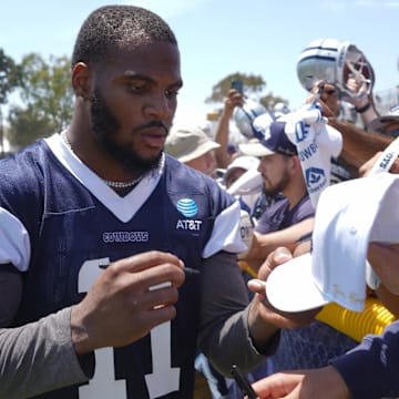 Dallas Cowboys linebacker Micah Parsons signs autographs during training camp at the River Ridge Fields.